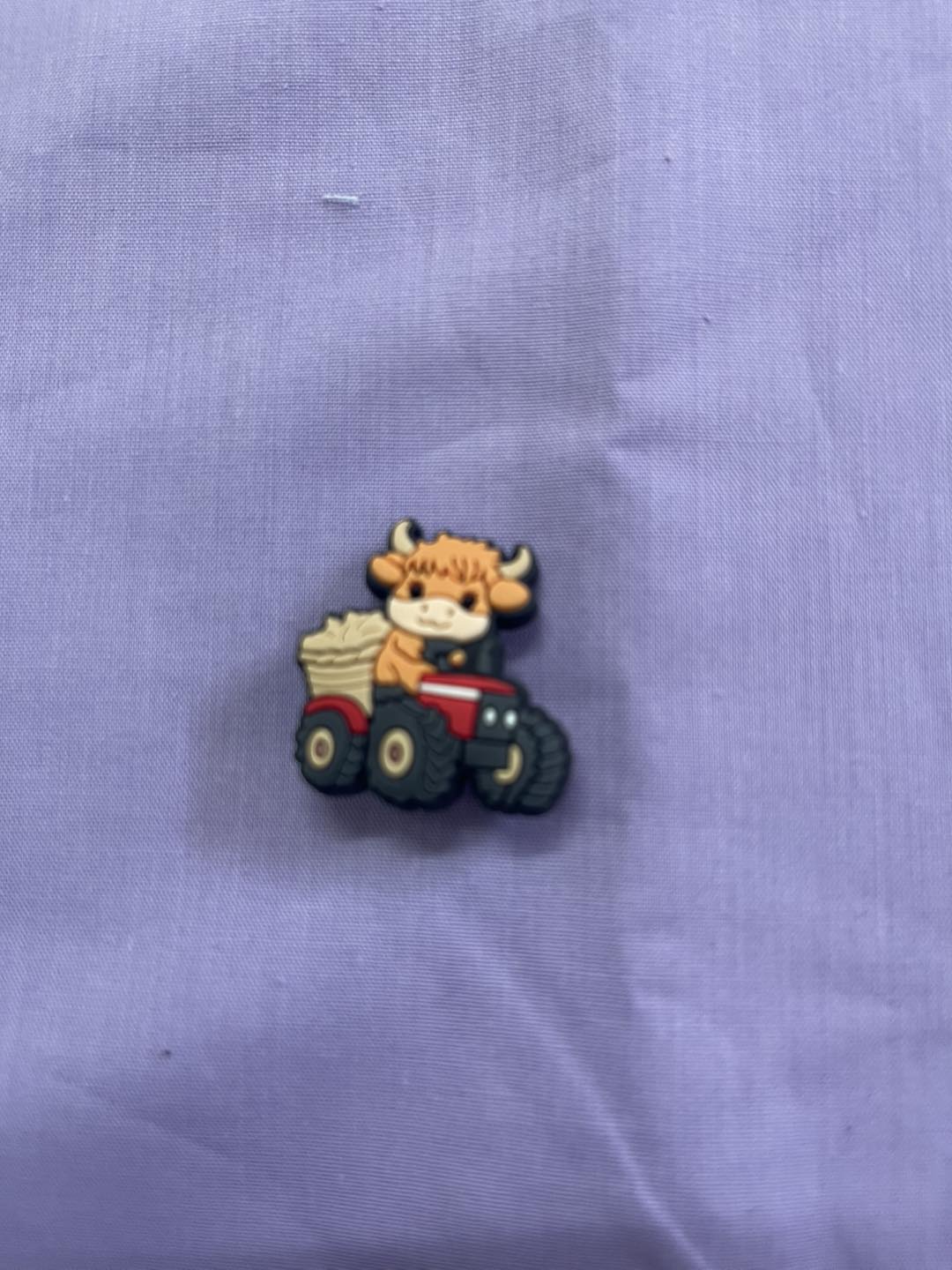 Croc Charm - Highland cow - on tractor